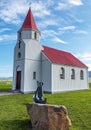 Rural church in Glaumbaer locality of Northern Iceland. The statue at foreground, it is a depiction of Gudridur Thorbjernardottir Royalty Free Stock Photo